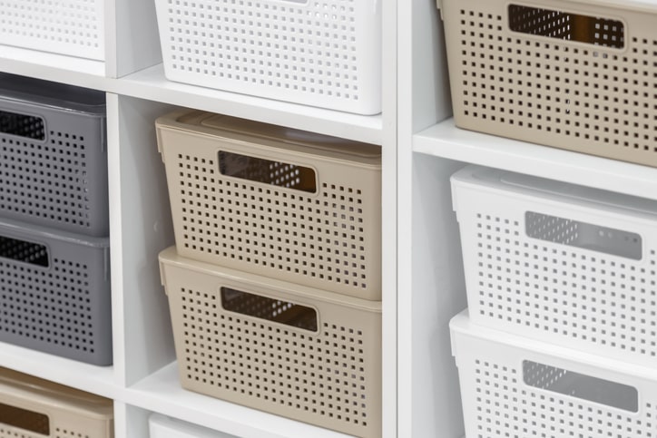 Cube storage organizer with a variety of white, tan, and gray containers.